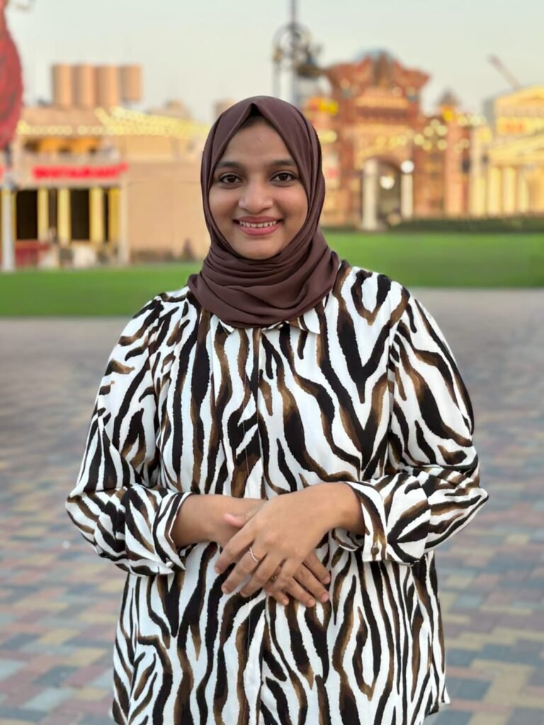 Digital Marketer In Kerala smiling outdoors in brown hijab